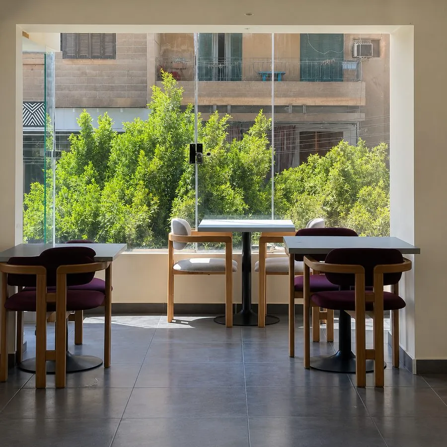 Window-side seating overlooking the street at Paccino's Minya